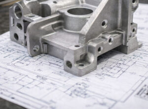 Aluminum casting ontop of a blueprint